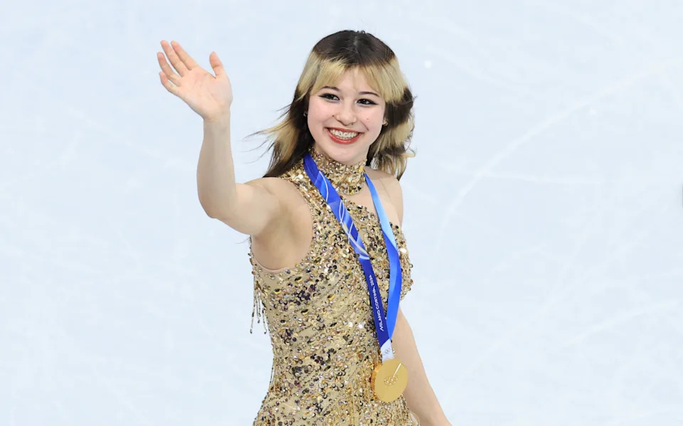 Alysa Liu of the United States celebrates with the gold medal in the women's free skate.Katie Stratman-Imagn Images