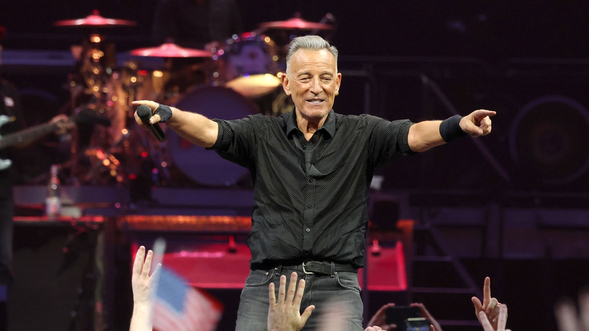 Bruce Springsteen performing on stage at a concert
