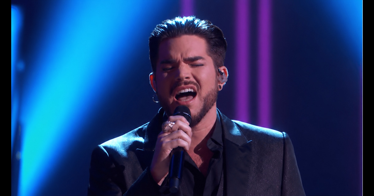 Edited illustration of Adam Lambert passionately singing Believe under blue concert lighting.