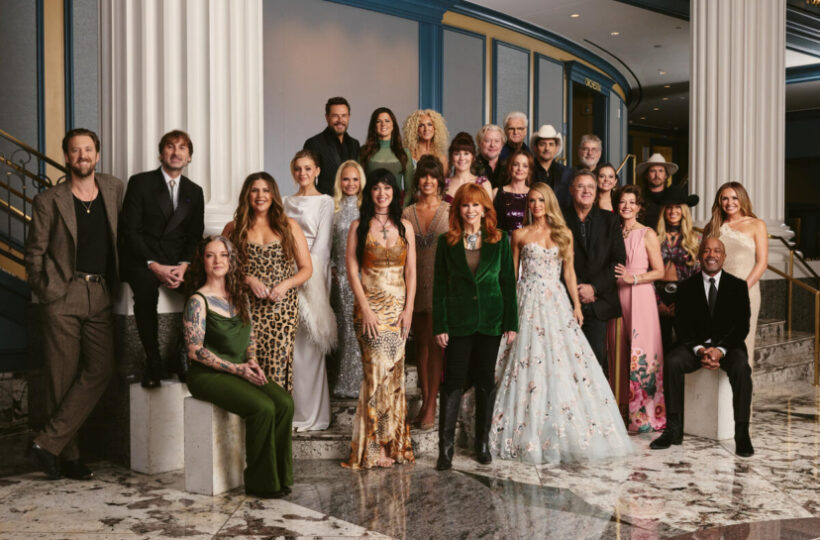 Performers and guests, including Reba McEntire and Carrie Underwood, pose for a group photograph at the October 21, 2026 Dolly Parton tribute in Nashville.