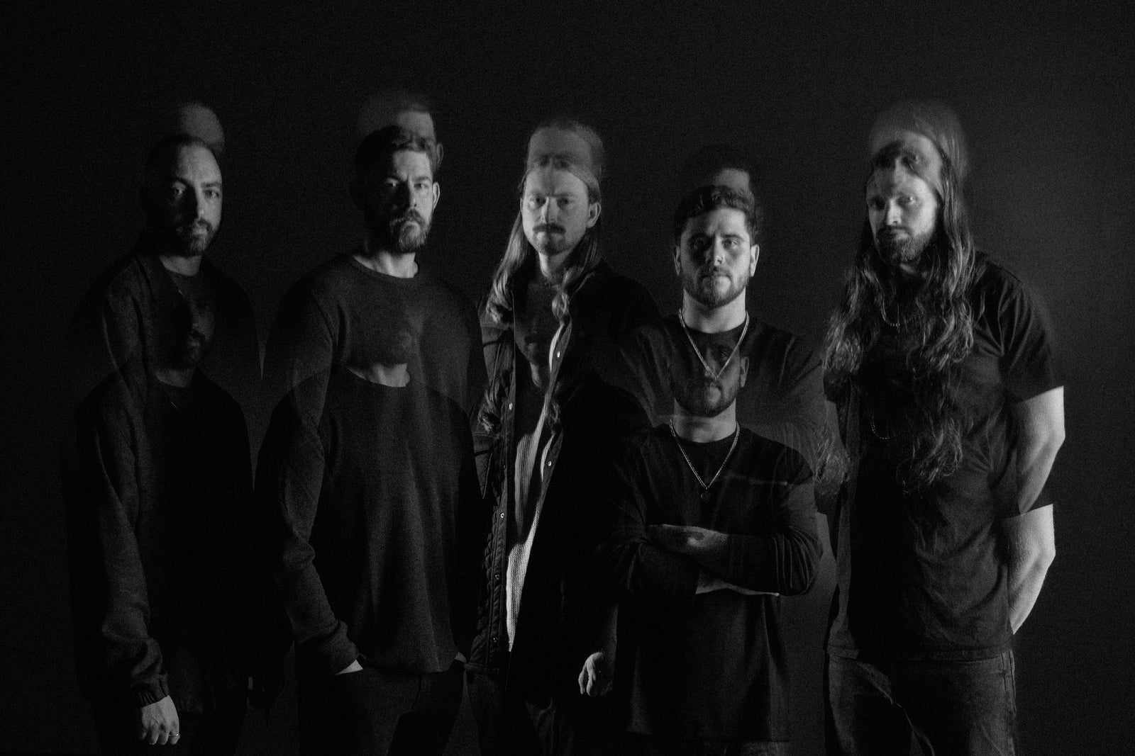 Black-and-white promotional portrait of the five members of Currents with overlapping exposures