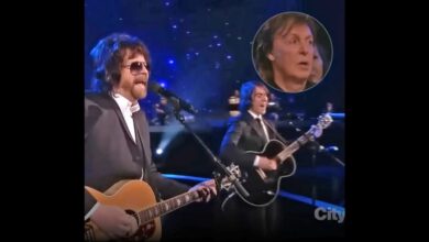 Jeff Lynne and Dhani Harrison performing Something during the 2014 Beatles tribute, with Paul McCartney shown watching.
