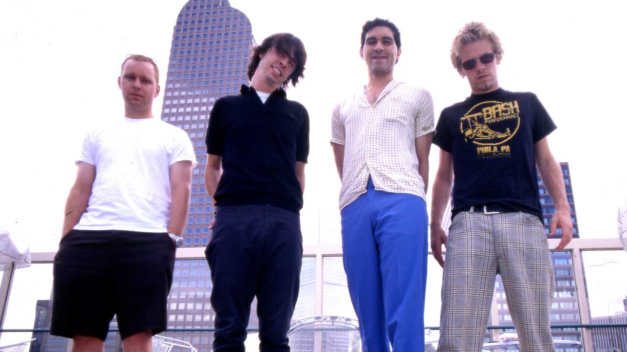 Foo Fighters standing together on a rooftop in an archive photograph from 1998