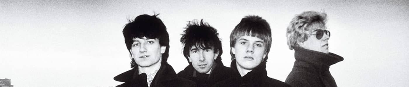 Black-and-white archive photograph of U2's four members in their early years